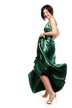 Having fun and smiling with a green dress in a white isolated studio