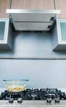 Clouseup range hood - detail of a modern kitchen. Vertical view