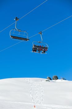 Skiers on a ski-lift of Zell am Ziller, Tirol, Austria. Vertical view