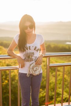 asian girl standing with sunset on the background