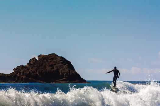 Surfer Comes Ashore at  Leo Carrillo State in Malibu, California.