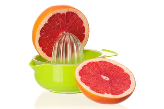 Glass of fresh grapefruit juice, juicer and grapefruit fruits on white background