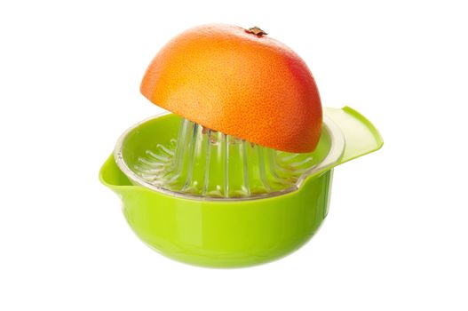 Plastic juicer for citrus with grapefruit fruits on white background