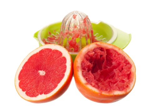 Glass of fresh grapefruit juice, juicer and grapefruit fruits on white background