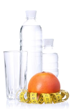 Fresh ripe grapefruit with measure tape and Bottled water on white background