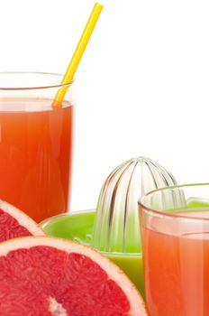Glass of fresh grapefruit juice, juicer and grapefruit fruits on white background