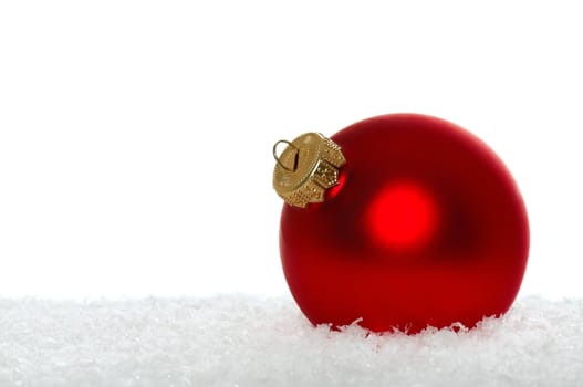 Red christmas bauble with snow on white background