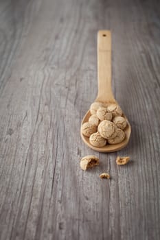 Crunchy sweet italian amaretti on a wooden spoon