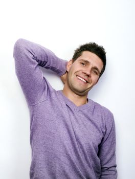 Charismatic young man who leans against the wall and looking at camera