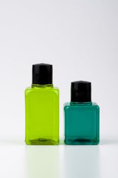 Two green color shampoo and bottles