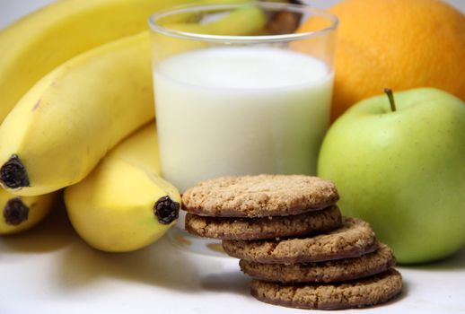 Healthy breakfast: milk, cookies and fruits