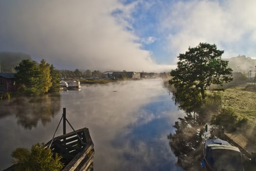 fog and smoke in the tista river in halden, image is shot on a cold autumn morning.