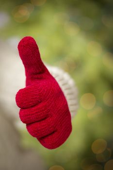 Woman in Sweater with Seasonal Red Mittens Holding Out a Thumb Up Sign with Her Hand.