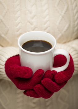 Woman in Sweater with Seasonal Red Mittens Holding a Warm Cup of Coffee.