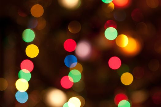 Glowing bright colourful christmas lights abstract background
