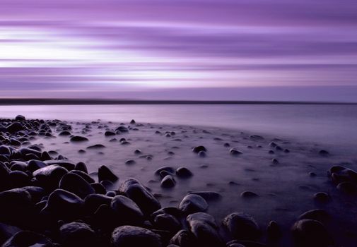 A pebble beach at twilight in Northumbria