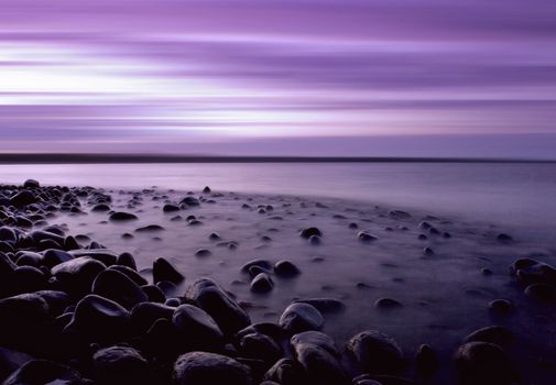 A pebble beach at twilight in Northumbria