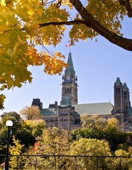 The Canadian Parliament surrounded by autumn leaves at noon in Ottawa, Canada.