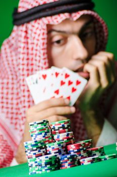 Arab playing in casino - gambling concept with man