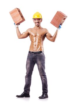 Muscular builder with bricks on white