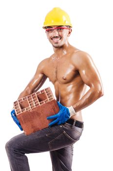 Muscular builder with bricks on white