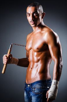 Strong man with nunchaku