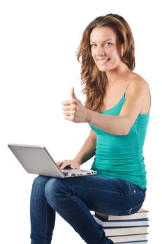 Student with netbook sitting on books