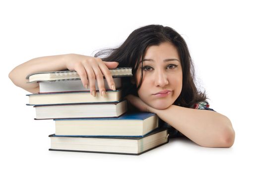 Tired student with textbooks on white