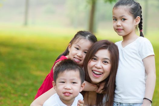 Outdoor park happy Asian mother and children