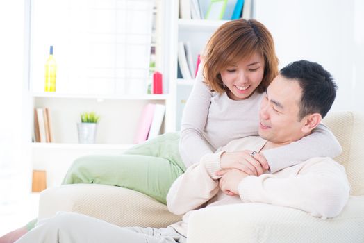 Asian couple having sweet talk at home