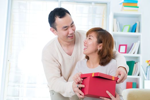 Asian young Man handing over love gift to young woman