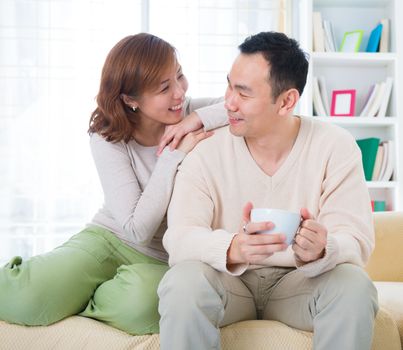 Asian couple having conversation at home