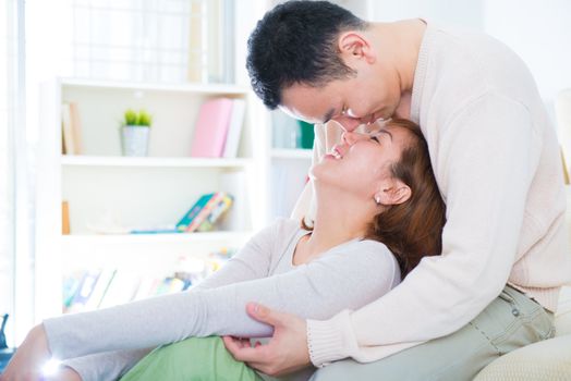 Loving Asian couple having fun time at home
