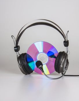headphones and compact disc on a white background