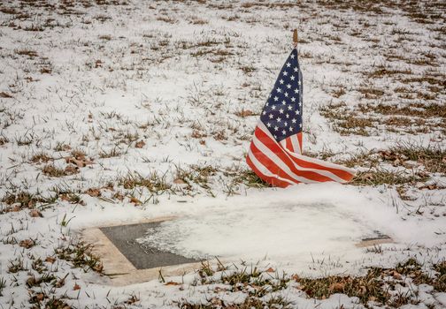 A Veteran's Grave in a Rural American Cemetery in Winter.