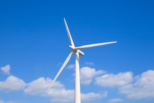 Wind turbine set against clear blue sky