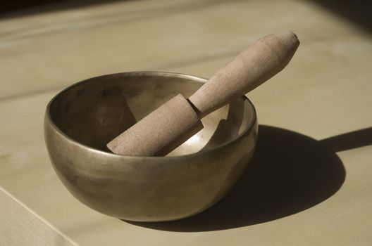 Tibetan bowl on table with a mallet