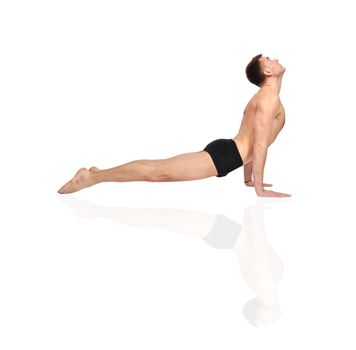 Young man doing yoga exercise
