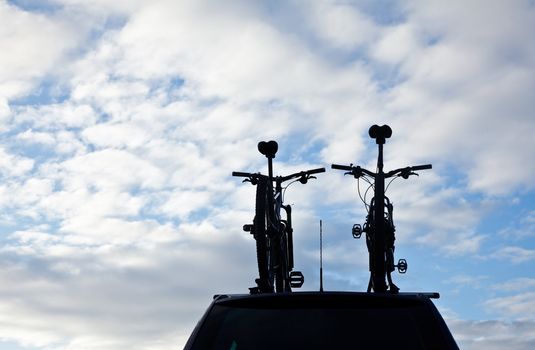 Car with bicycles on a roof rack silhouette