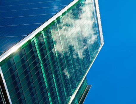 Sky and clouds reflected in a modern office building glass facade