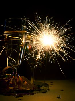 Two glasses of champagne with burnning sparkler