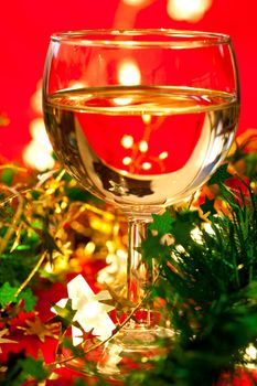 Glass of white wine with Christmas decoration, very shallow DOF