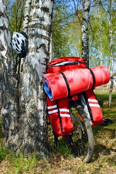 Loaded touring bicycle and helmet on rest break