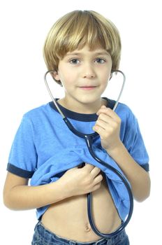 Young child hoping to grow up to be a doctor listens to his heart with stethoscope on white background