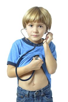 Young child longs to become a doctor as he checks his heart with a stethoscope on white background