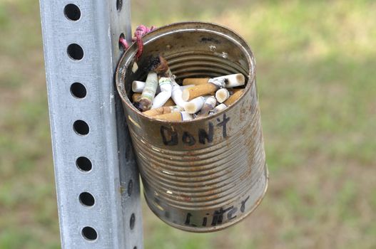 Don't litter can filled with dirty cigarrette butts