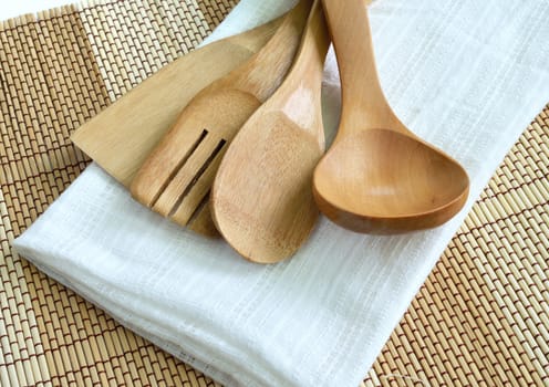 Wooden cooking utensils on wood background