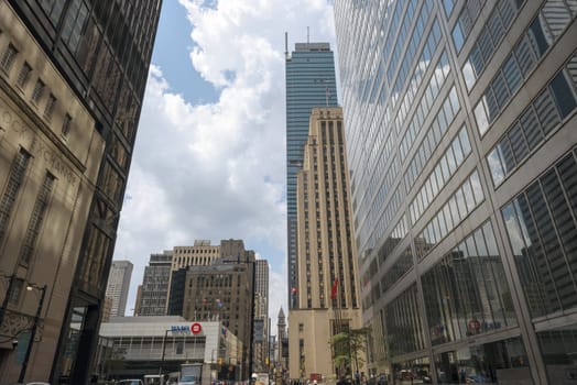 July 4, 2012 busy Bay Street in Toronto financial district. Building on the left Toronto Stock Exchange  tall building Trump condo project.