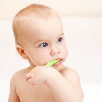 Little baby girl with green tooth brush