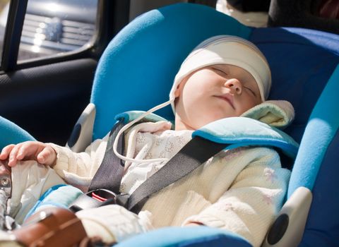 Toddler sleeping in a car seat